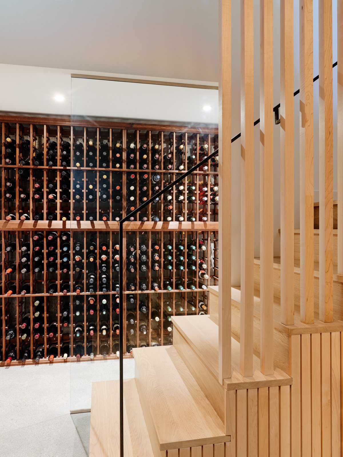 Wine room: cedar-slat enclosure, full bottle wall, glass partition.
